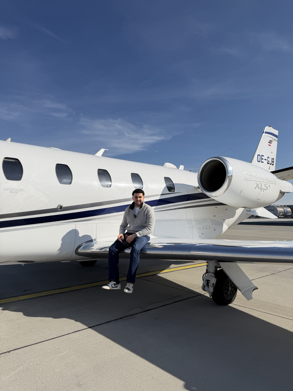 Omar Gawwad sitting on the wing of a Citation XLS+